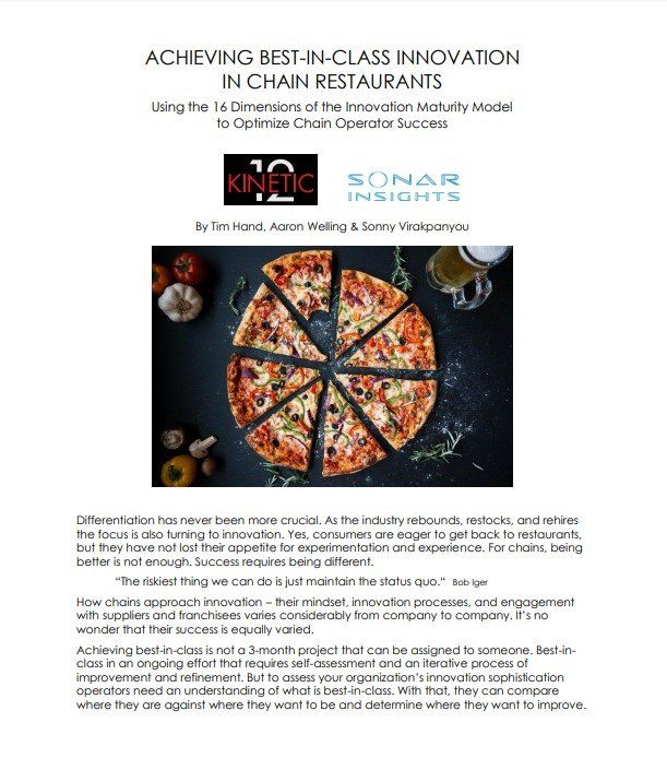 A pizza is being cut into slices on a table.