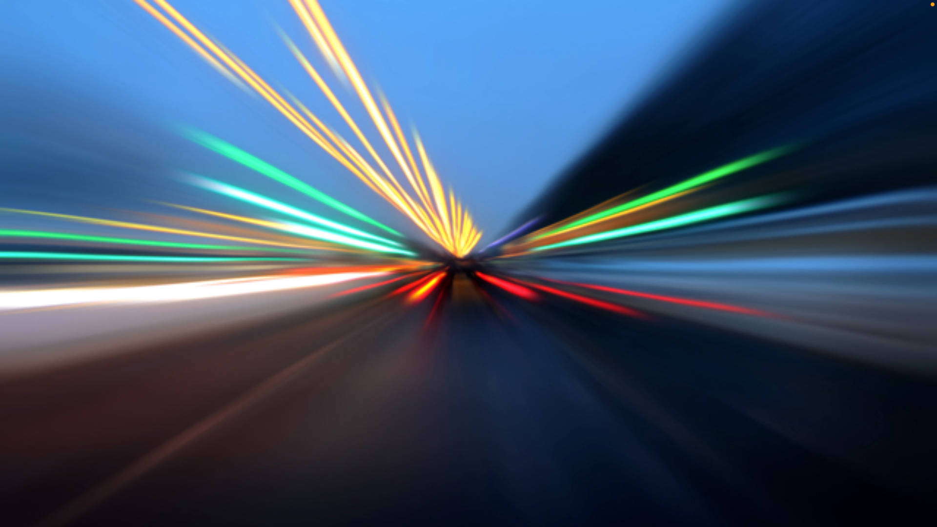 A blurry picture of a car driving down a highway at night