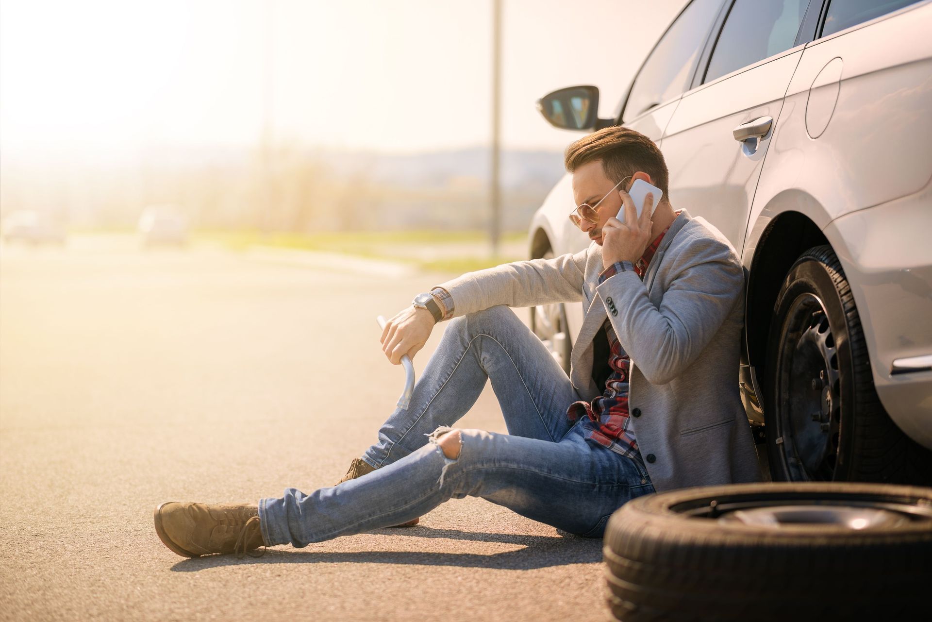 young man silver car that broke