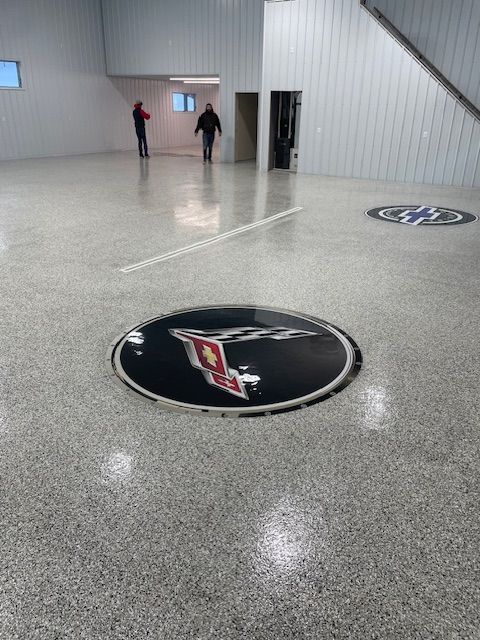 There is a logo on the floor of a building.
