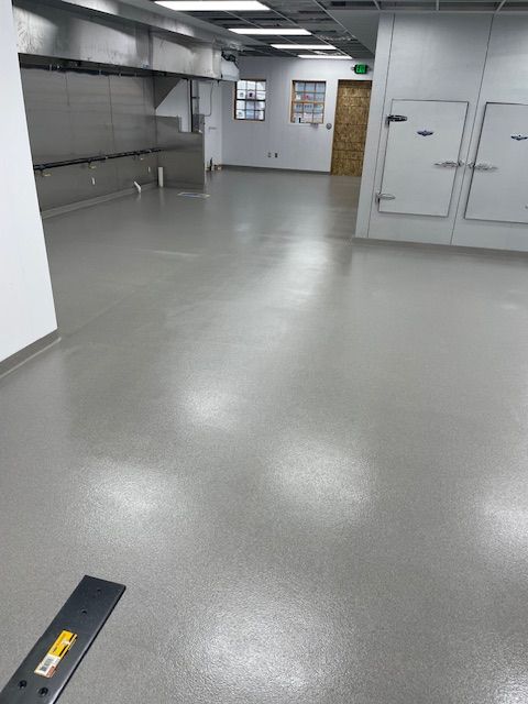A large room with a gray floor and white walls
