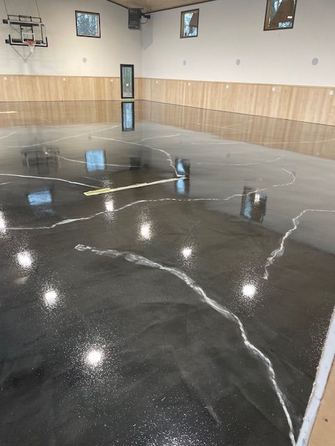 A basketball court with a cracked floor and a basketball hoop