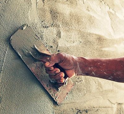 Concrete Contractors — Construction Worker Plastering Cement on Wall in Cinnaminson, NJ
