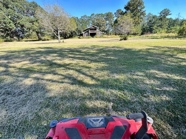 A picture of a big yard with a lawn mower in Mandeville, LA.