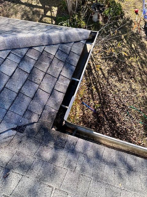 A picture of the top of a house with gutters on it.