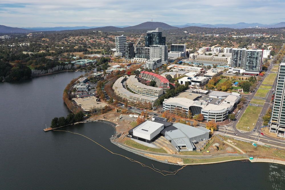 An Aerial View Of A City Surrounded By Water And Buildings  — Macgregor Auto In Belconnen, ACT