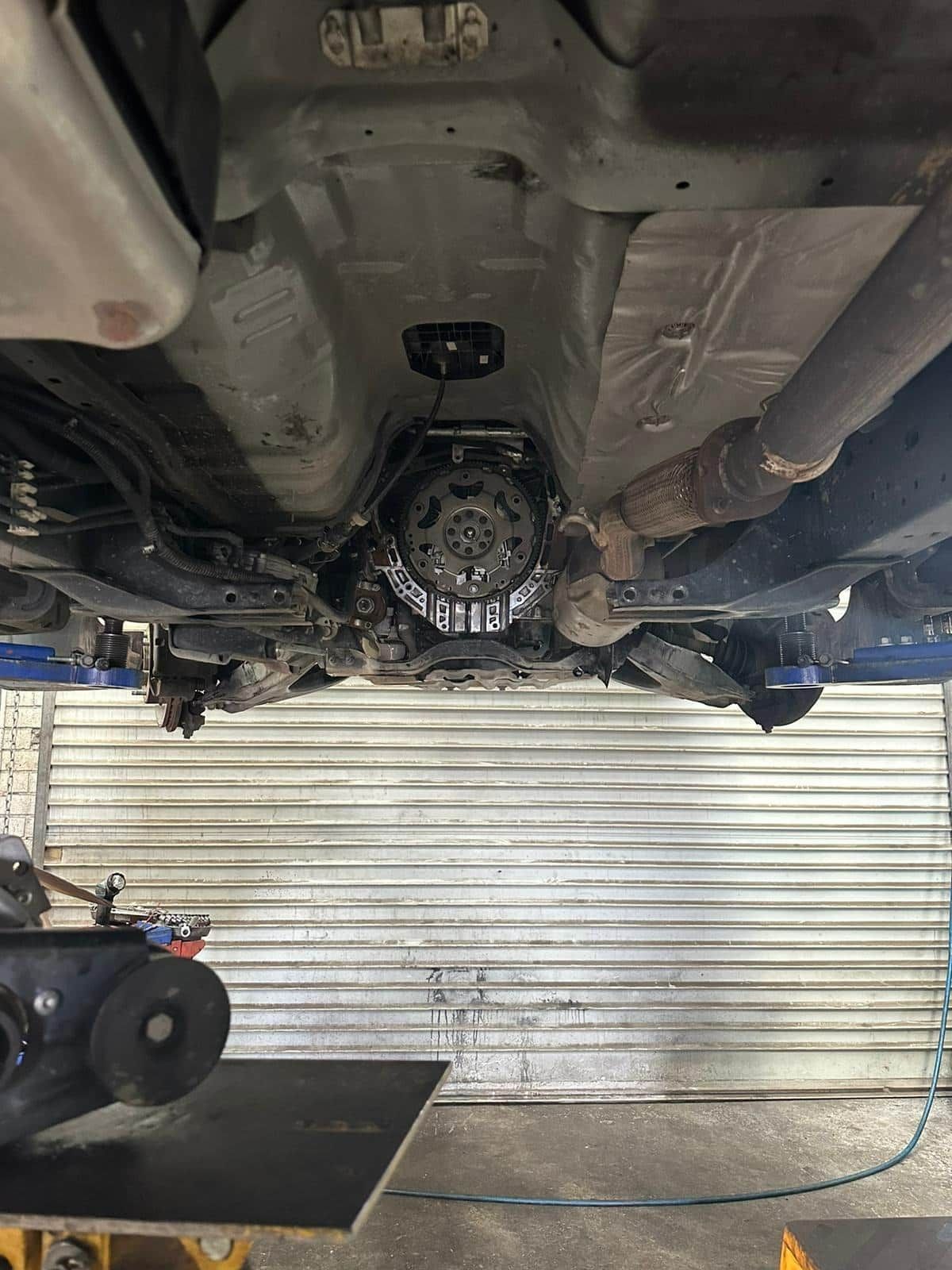 The Underside Of A Car Is Being Worked On In A Garage — Macgregor Auto In Belconnen, ACT
