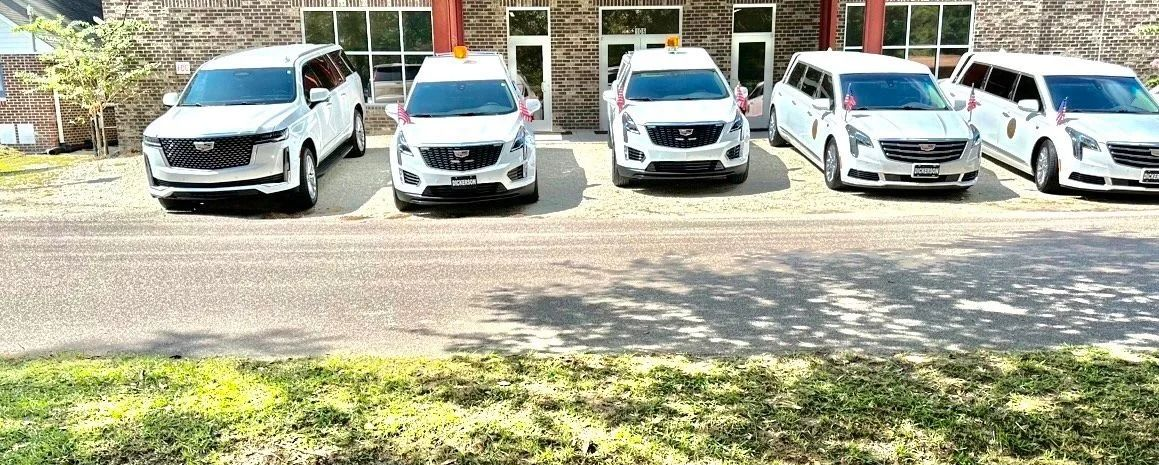White SUVs parked in front of a building.