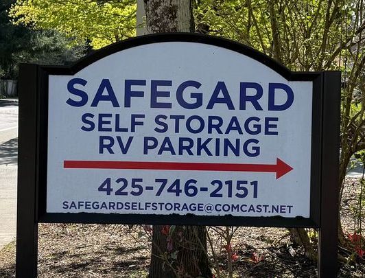 Sign for Safegard Self Storage & RV Parking, with contact info and arrow.