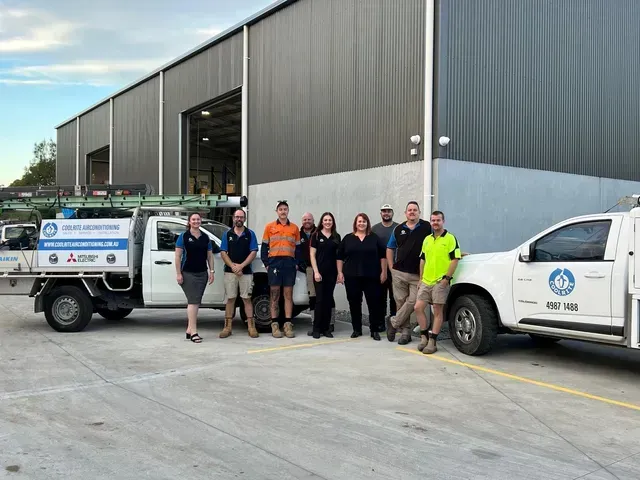 A group of people standing next to trucks in a parking lot — Air Conditioning Installer Hunter Valley