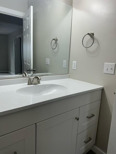 A bathroom with a sink and a mirror