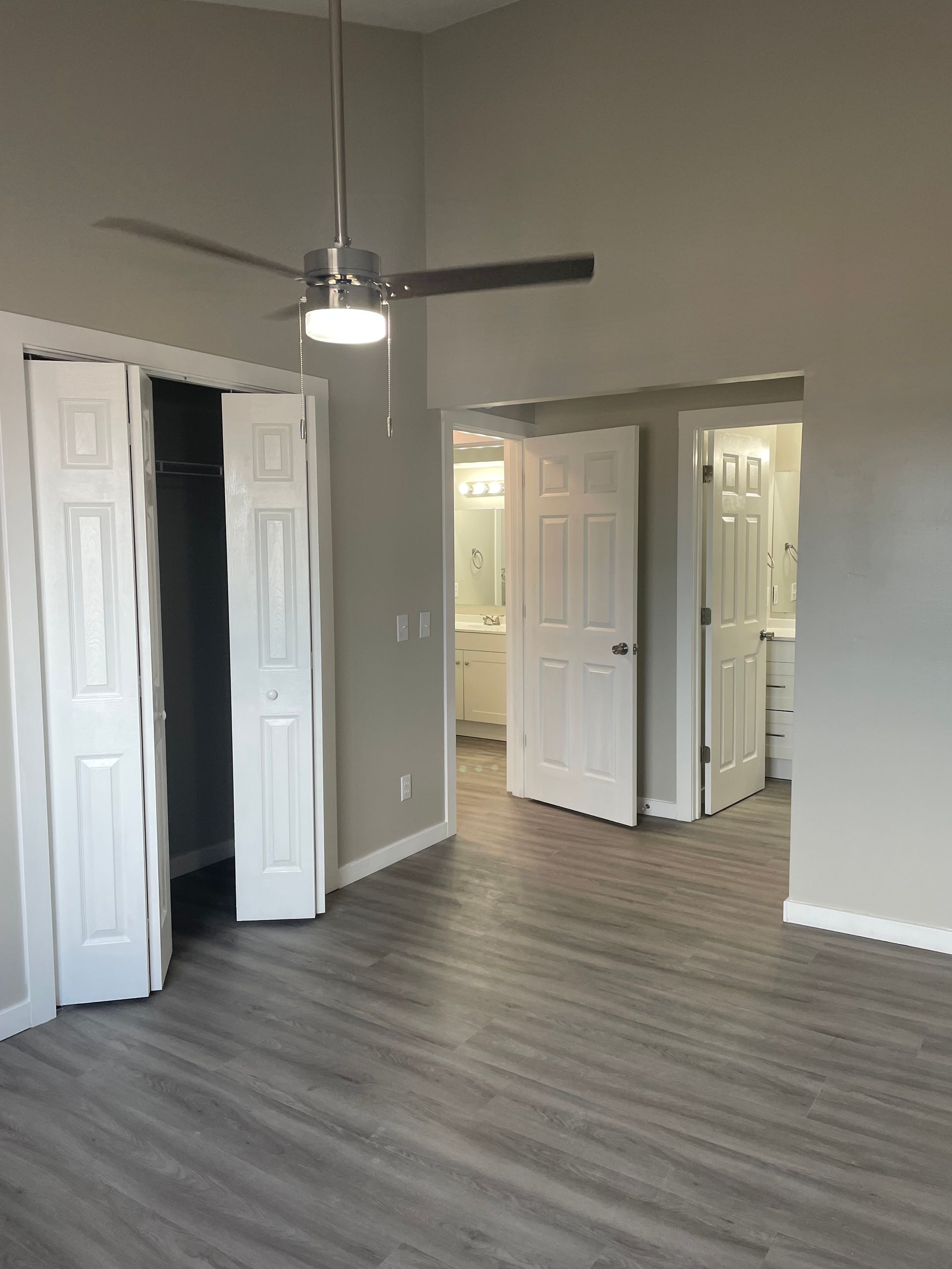 an empty basement with a wooden ceiling and a white door .