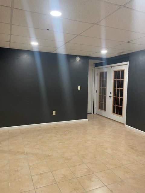 An empty room with black walls and a white door