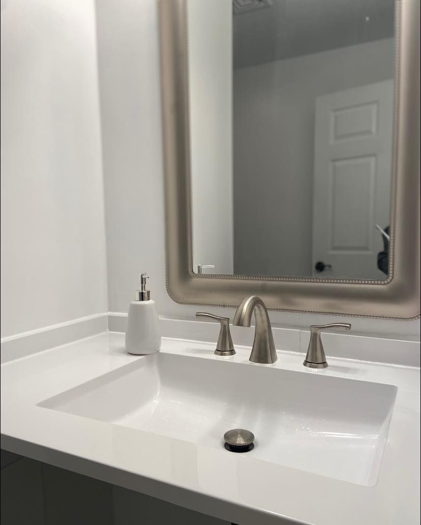 a man is standing on a ladder in a bathroom .