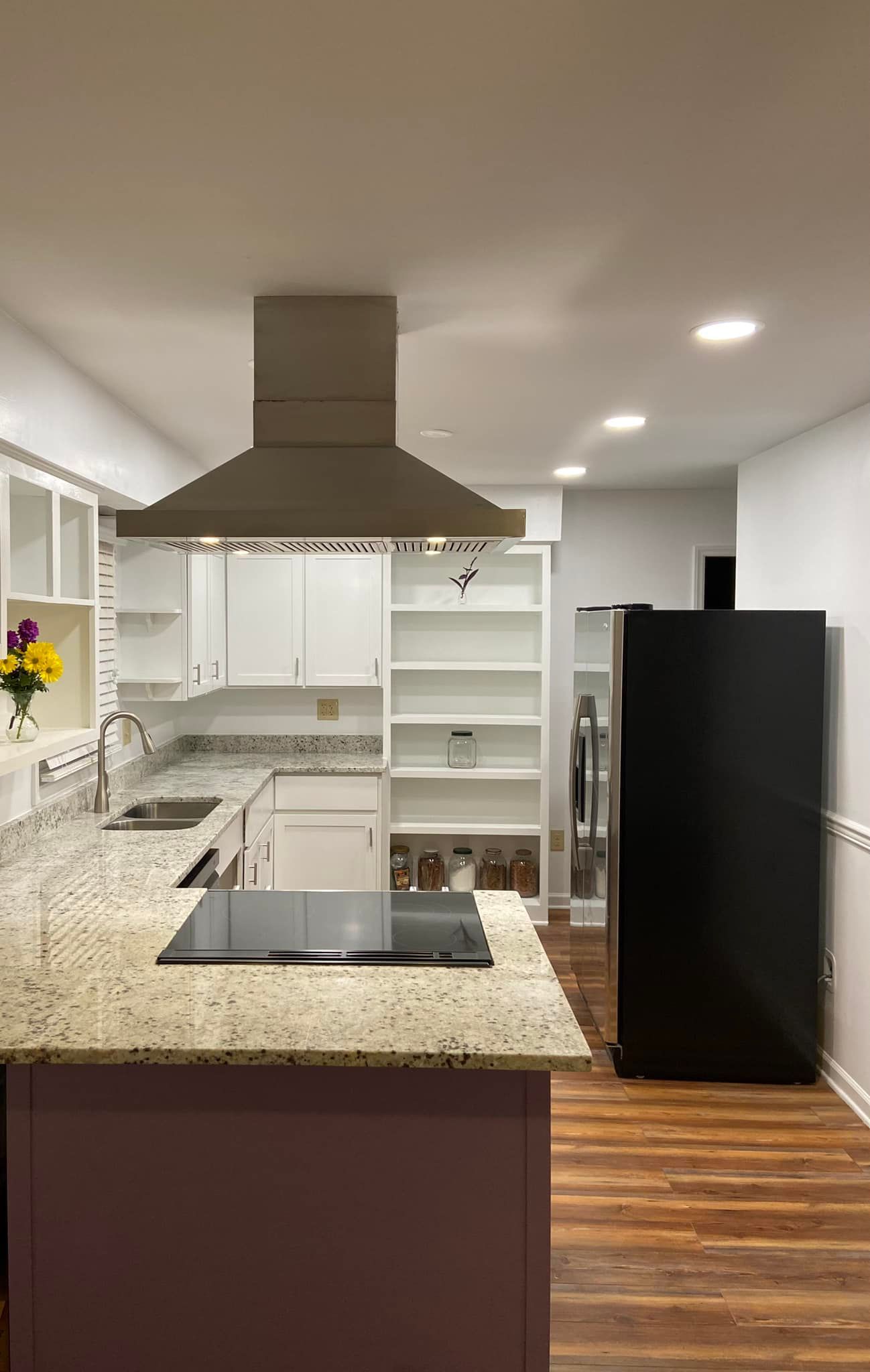 a kitchen under construction with a large island in the middle .