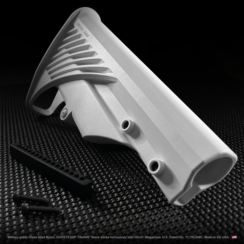 A white item with holes in it is on a black surface