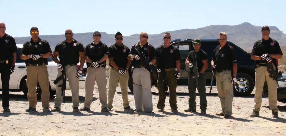 A group of men standing next to each other in the desert