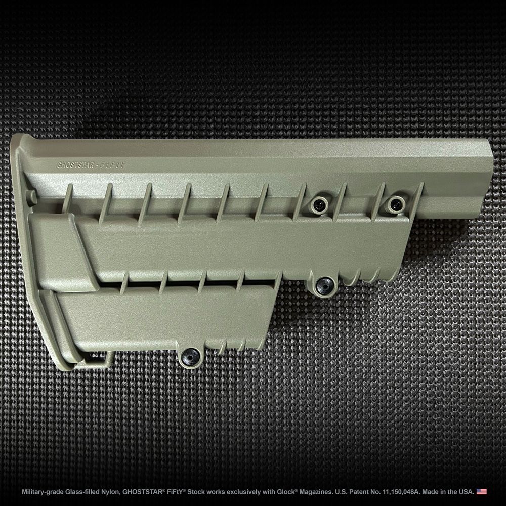 A close up of a gray plastic item on a black surface.