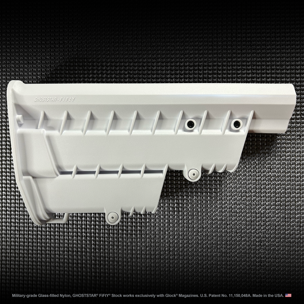 A white plastic item is sitting on top of a black mat.