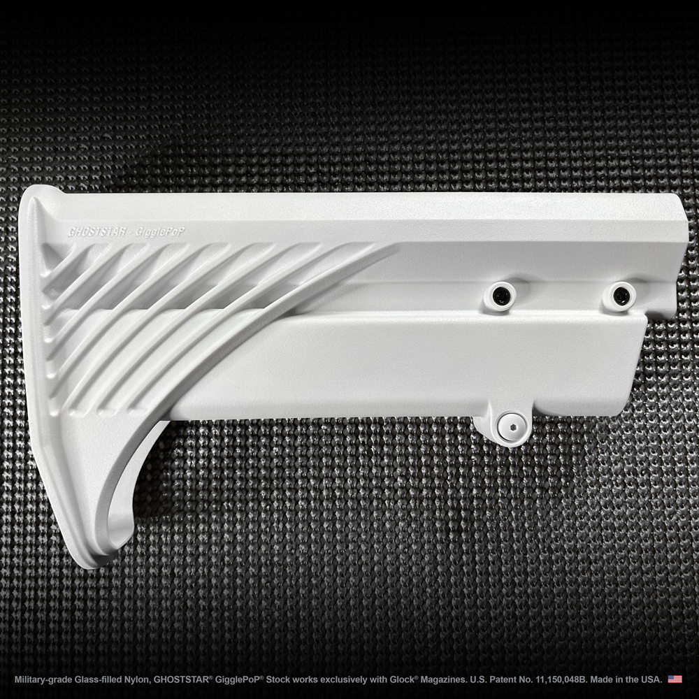 A white plastic item is sitting on a black surface