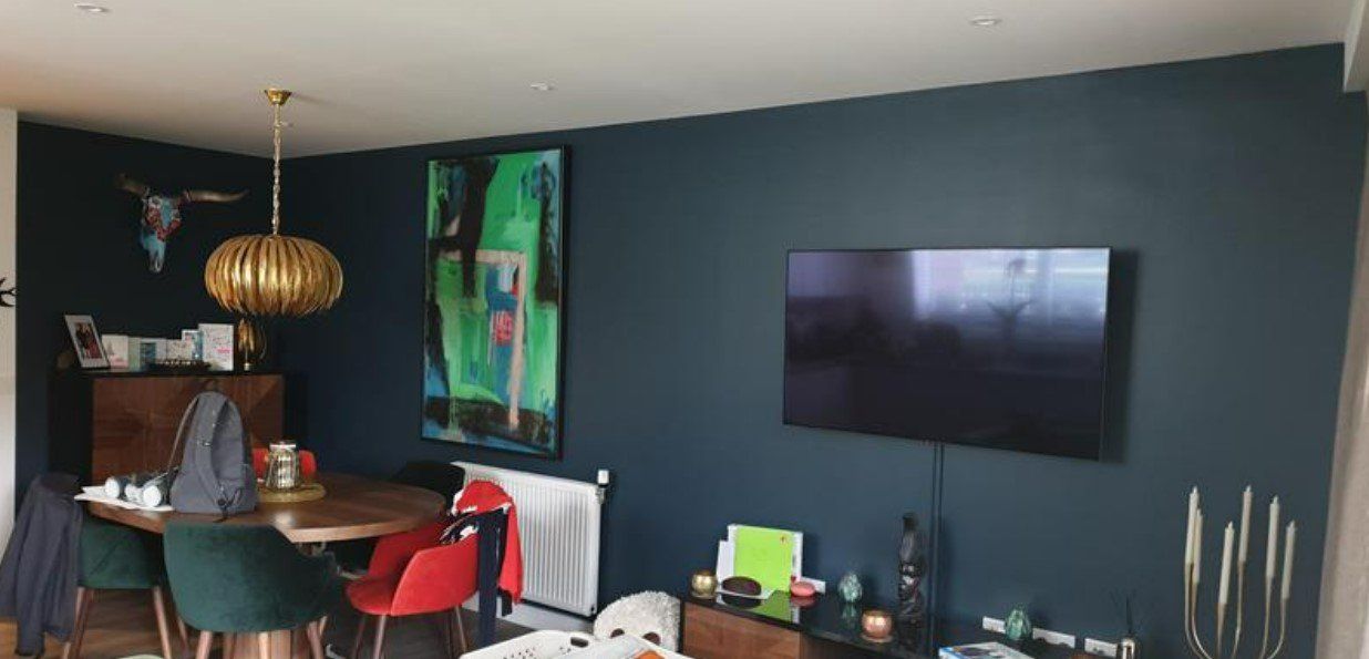 Picture of a new feature wall painted in dark green by painters and decorators Liverpool