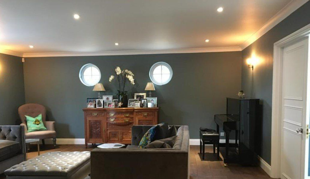 Picture of a living room feature wall in dark sage green by painters and decorators Liverpool