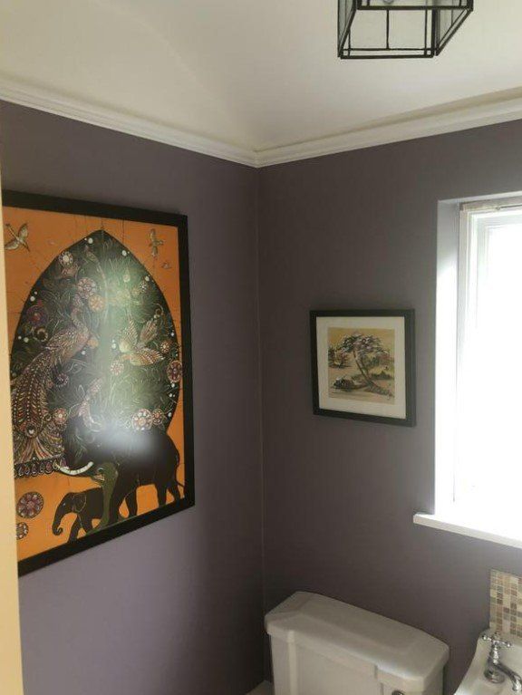 Picture of a study painted in mid grey with pictures hung on the feature wall by painters and decorators Liverpool