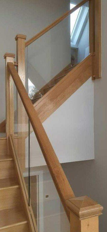 Picture of a timber staircase painted in white with glass panels by painters and decorators Liverpool