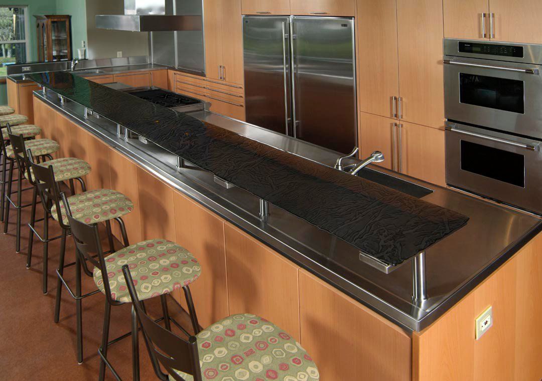 A kitchen with stainless steel appliances and granite counter tops