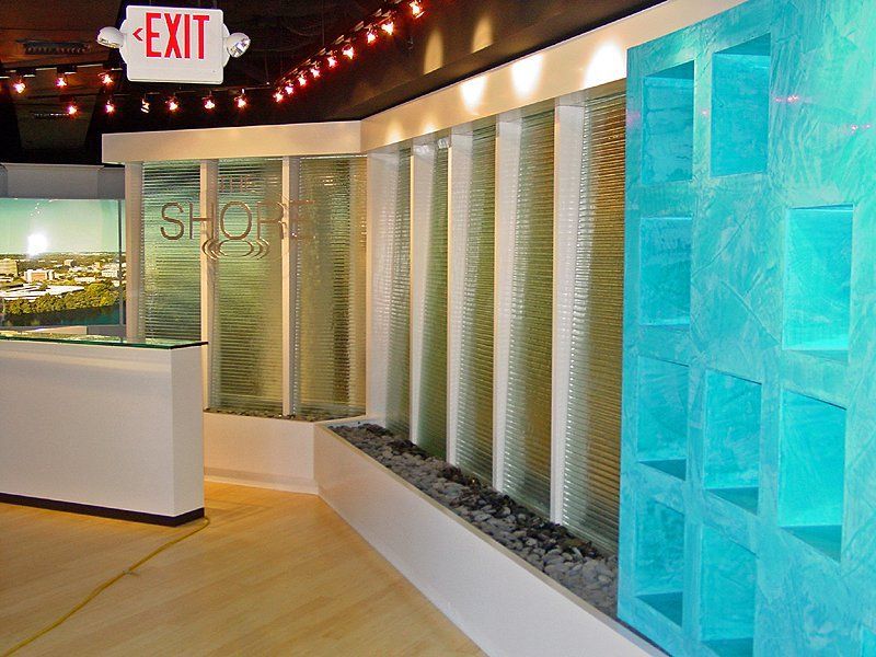 A white exit sign hangs above a reception desk