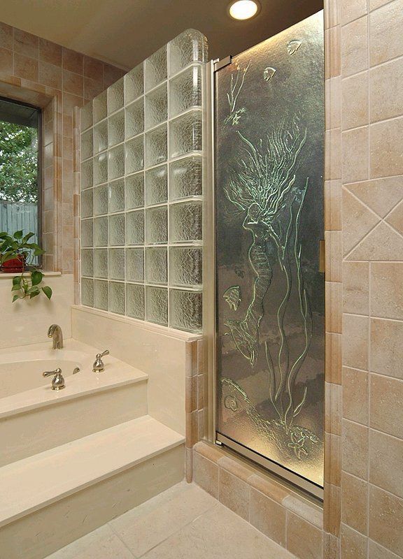 A bathroom with a bathtub and a glass shower door