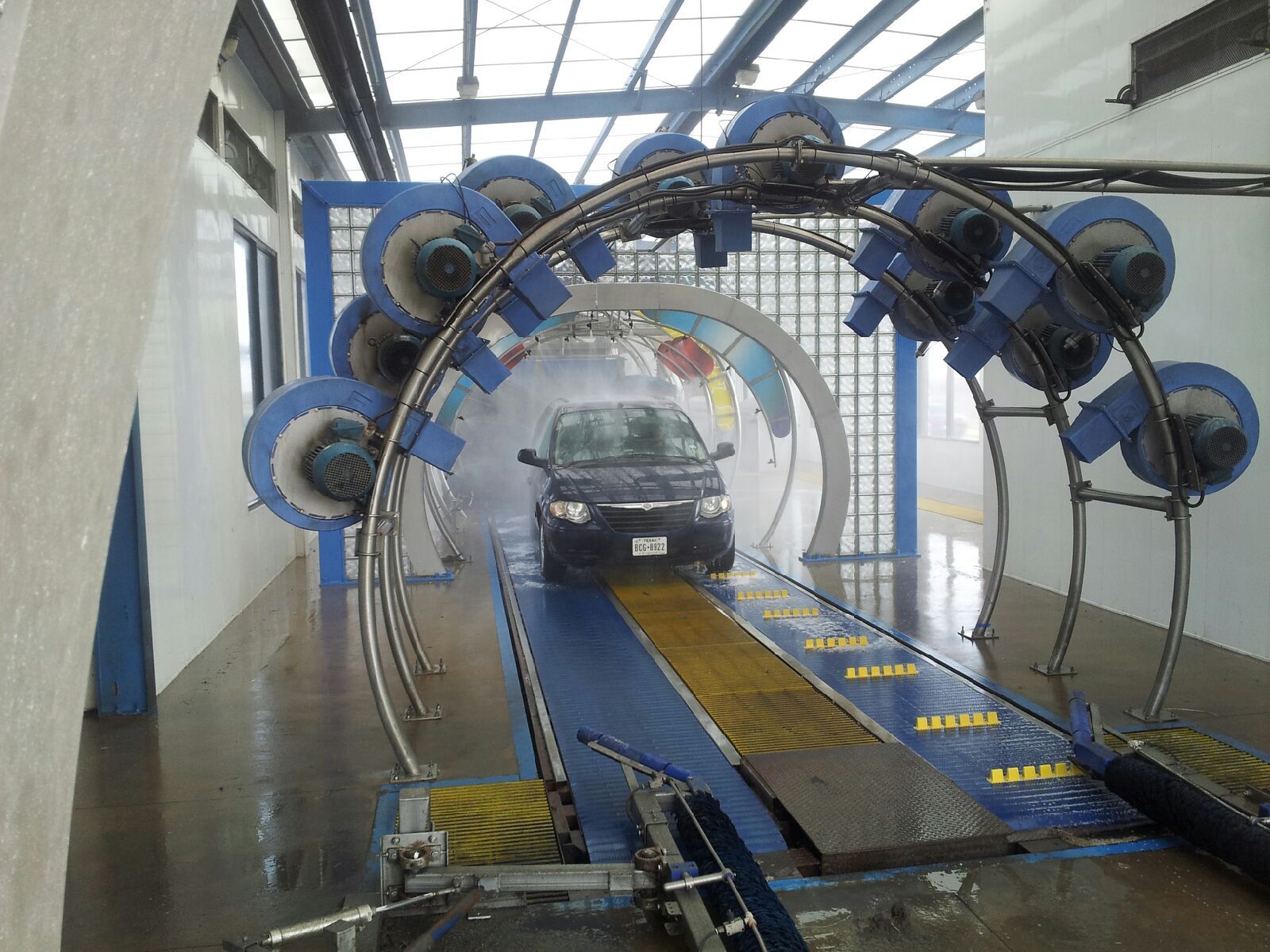A car is going through a tunnel at a car wash
