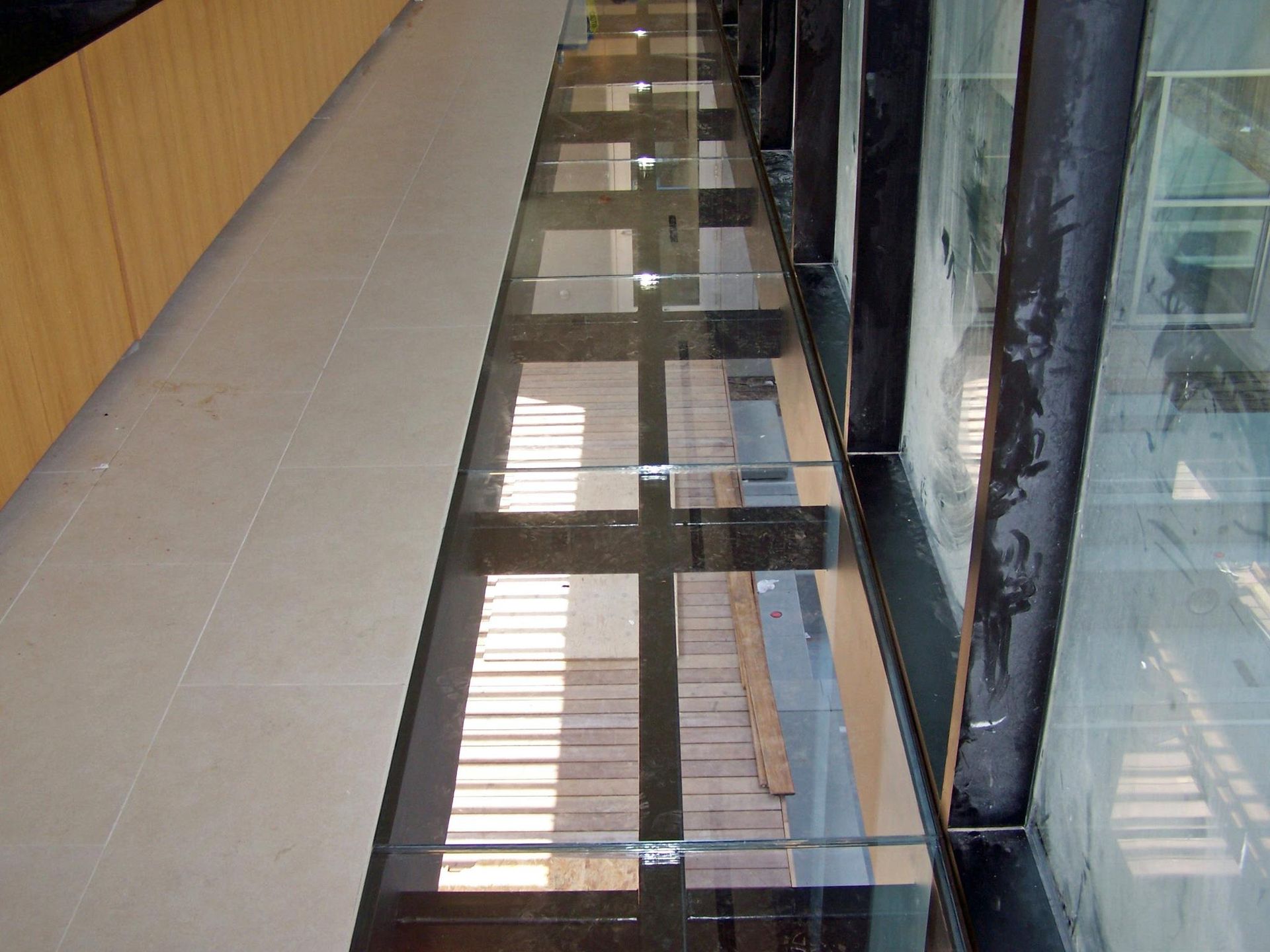 A hallway with a reflection of a building in the floor