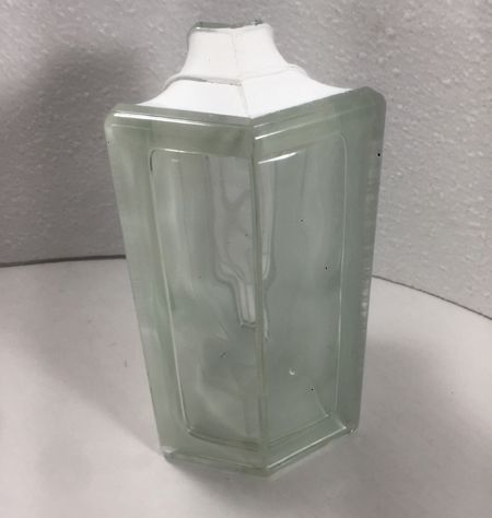 A clear glass vase is sitting on a white table