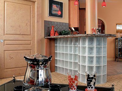 A kitchen with a bar made of glass blocks