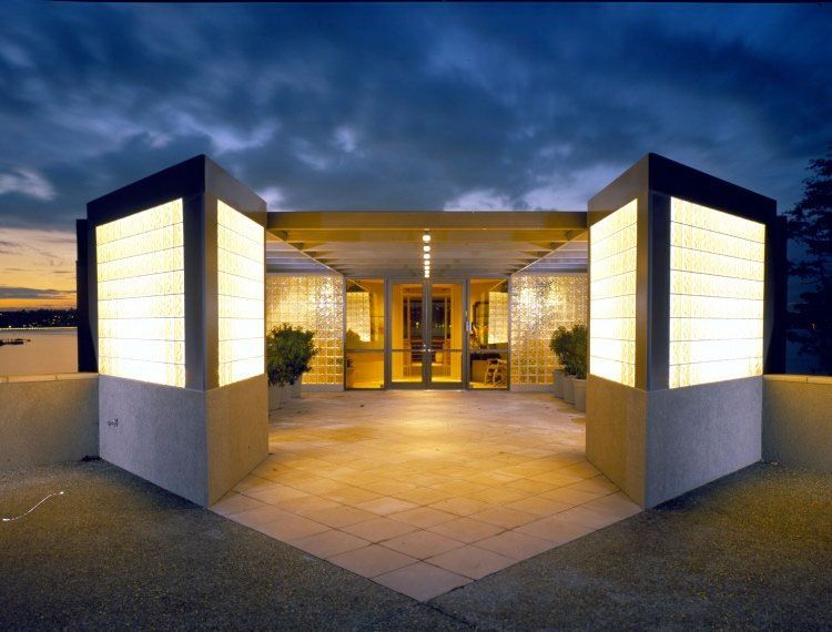 A building with a lot of windows and a sunset in the background