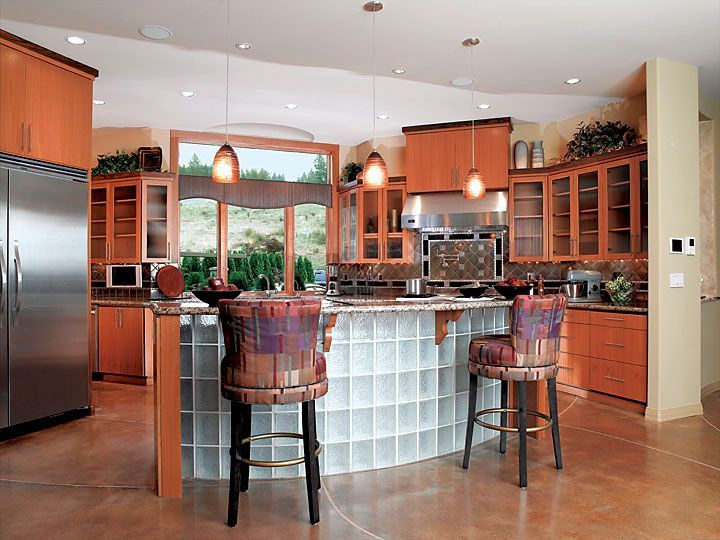 A kitchen with a large island and stools