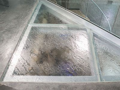 A glass floor with a triangle in the middle of it.