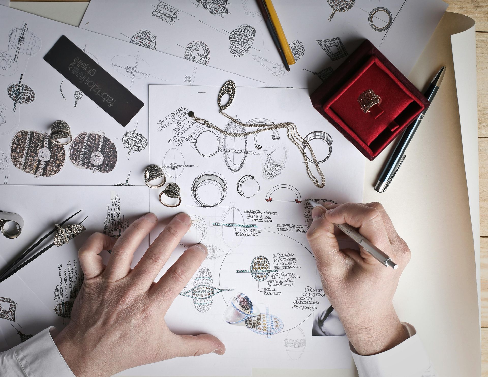 A person is drawing a ring on a piece of paper