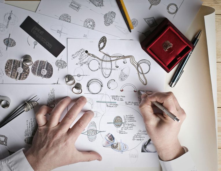 A person is drawing a ring on a piece of paper