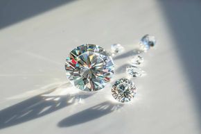 A group of diamonds are sitting on a white surface.