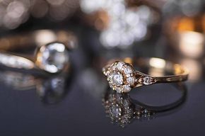 A close up of a diamond ring on a table.