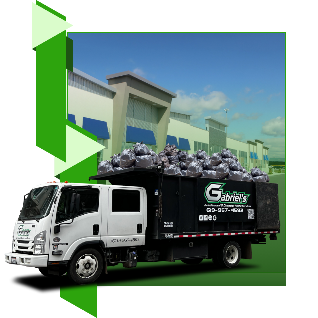 A garbage truck is full of garbage in front of a commercial store.