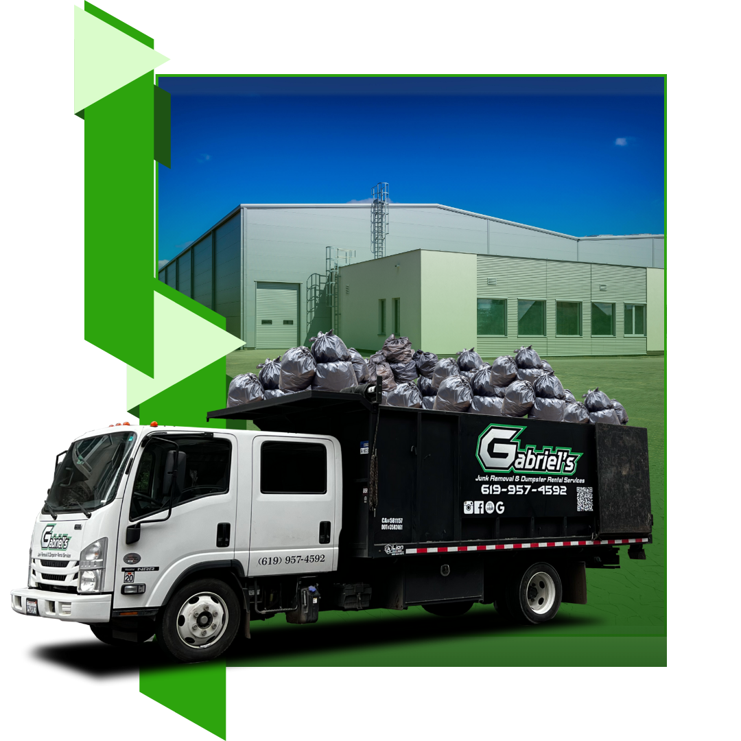 A garbage truck is full of garbage in front of a warehouse