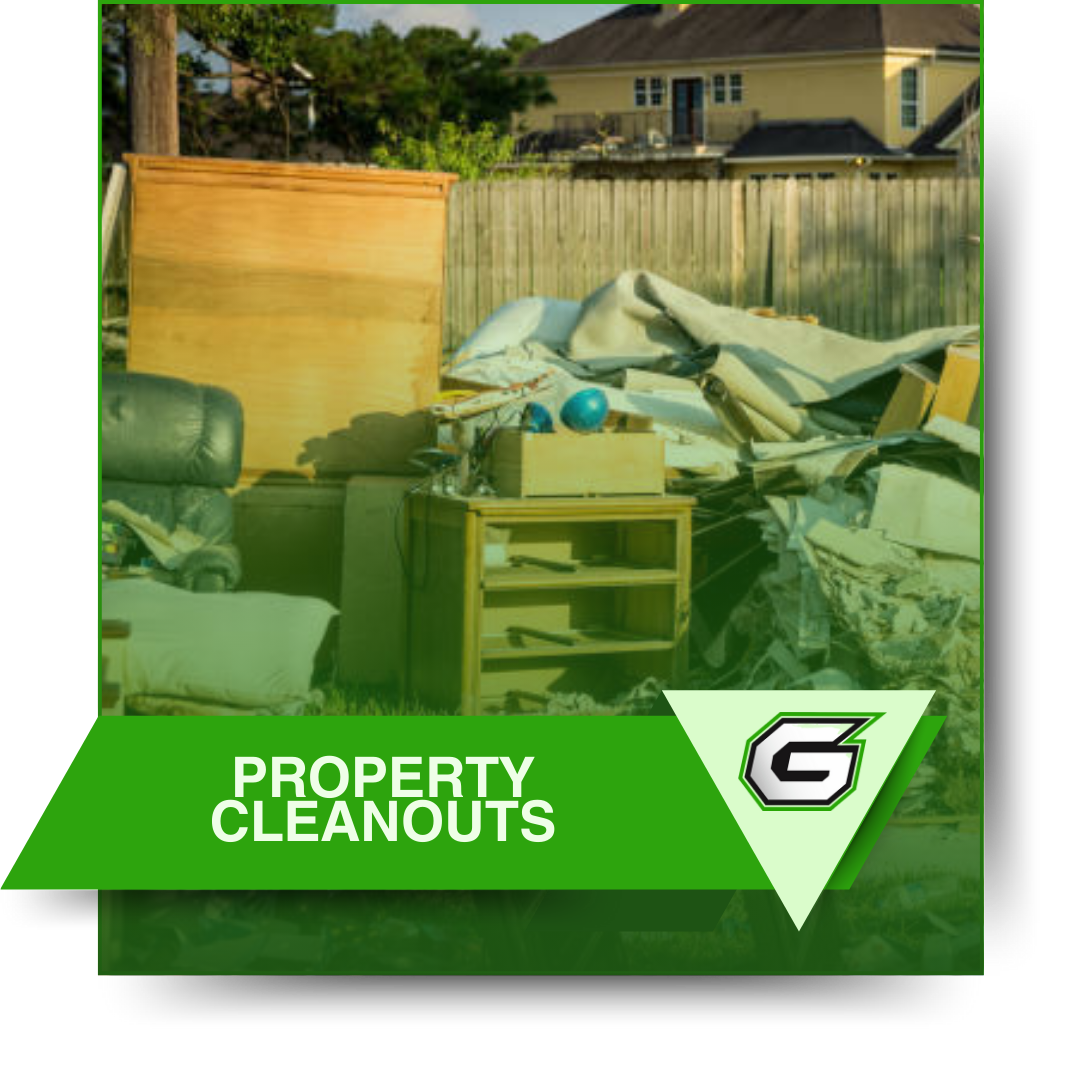 A picture of a pile of property cleanouts with a house in the background