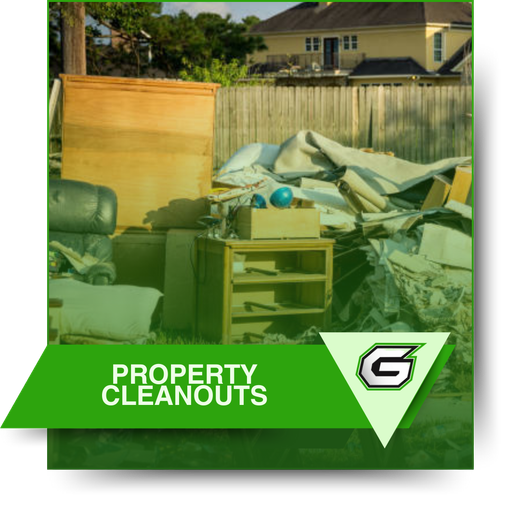 A picture of a pile of property cleanouts with a house in the background