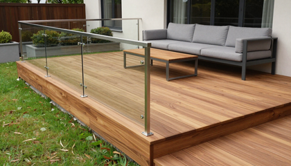 “Backyard deck with glass railing, wood flooring, and patio furniture built by deck builders in Hartford, CT”