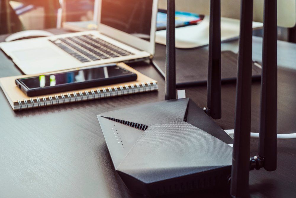 Laptop and Router Wireless on the Table — Superior Wifi In East Ballina, NSW
