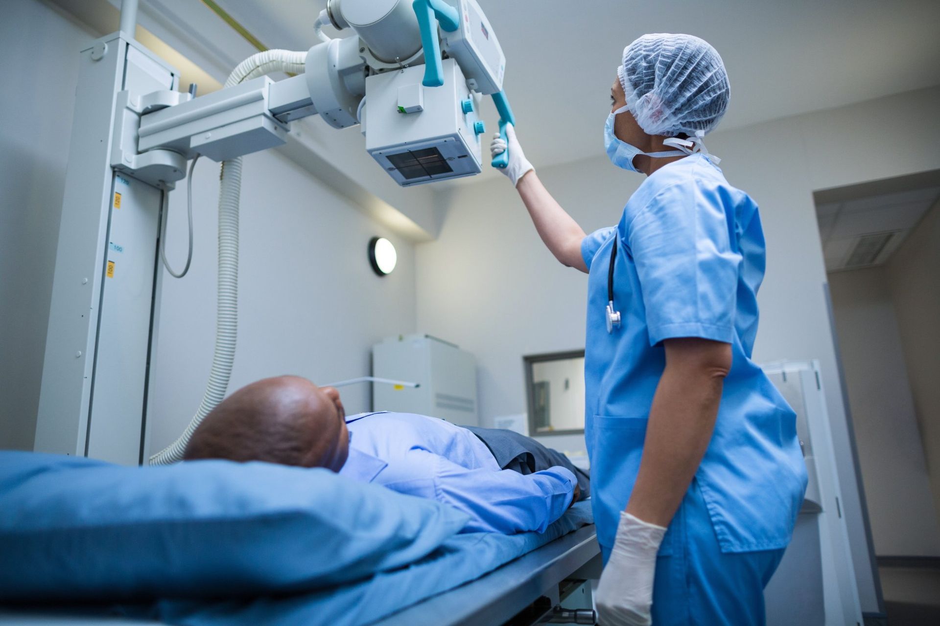 A nurse is taking an x-ray of a patient in a hospital.