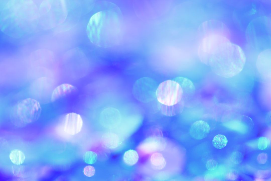 A blurry picture of a blue and purple background with bubbles floating in the air.